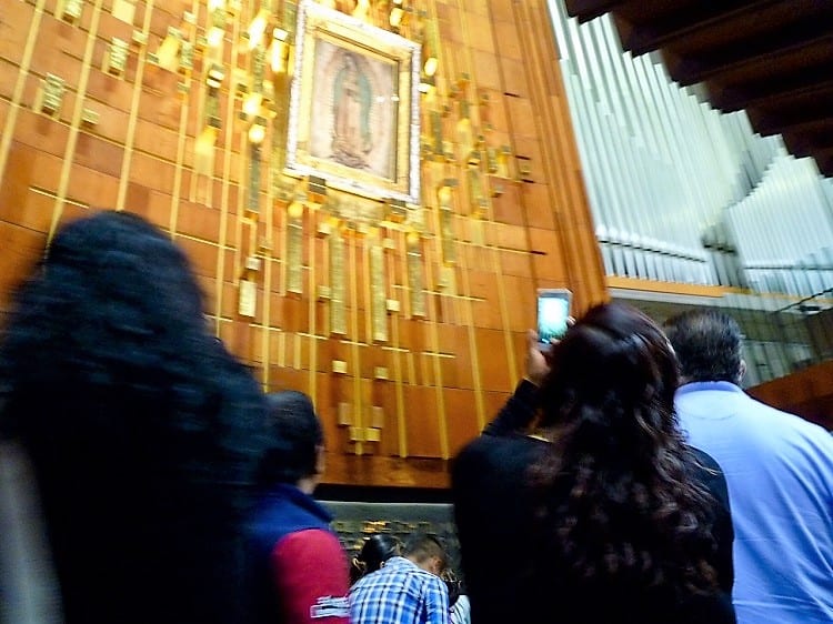 people looking at our lady of guadalupe -- a site to see in the mexico city travel guide