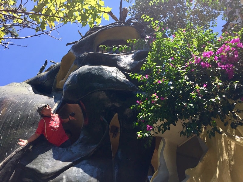 a man stands on an odd staircase outside the dalat crazy house