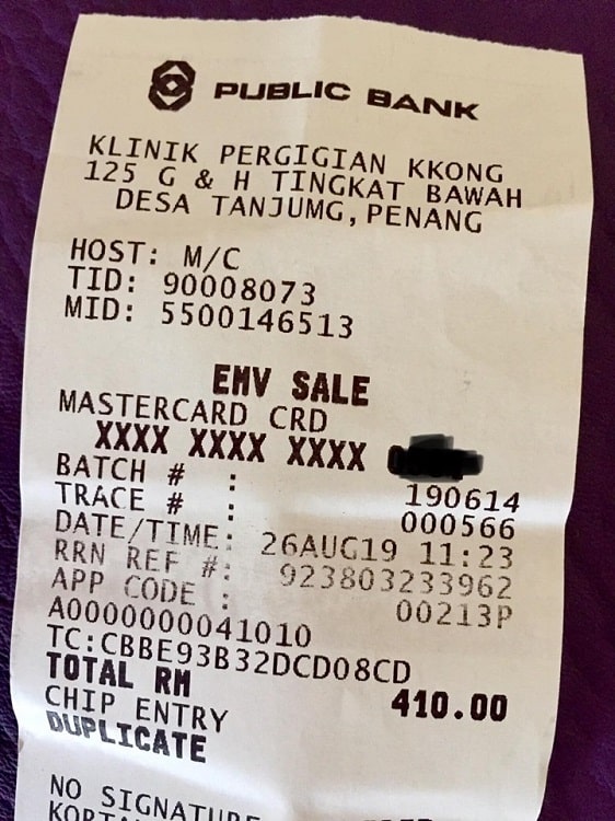 receipt for dental work shows the price in Malaysian ringgit, which is equivalent to about 97 USD