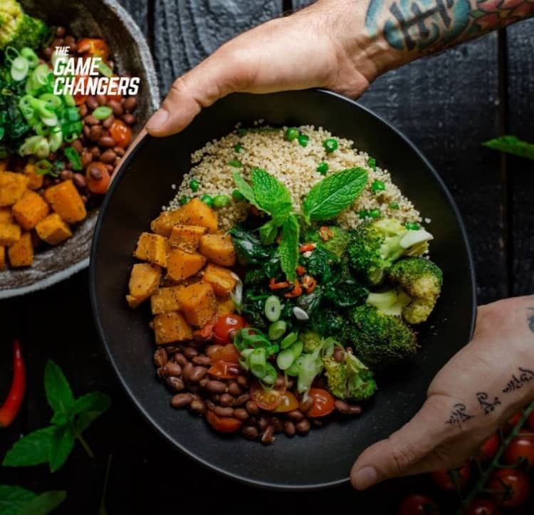 the game changers movie picture of a plate of vegan food - vegetables and beans
