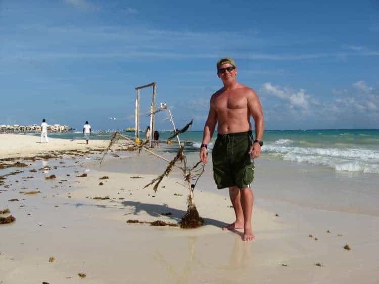 tedly stands by his trashy christmas tree on the beach in mexico