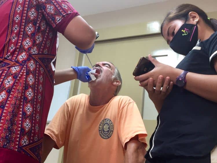 A specalist Philippine doctor examines Tedly's throat with a laryngoscope that has a camera in her office on Boracay Island at Salaver Clinic.