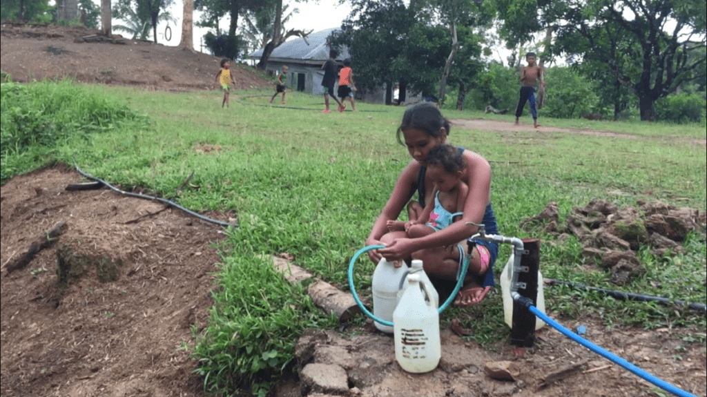 An Ati woman uses the new water spigot in Malay, Aklan, Philippines.