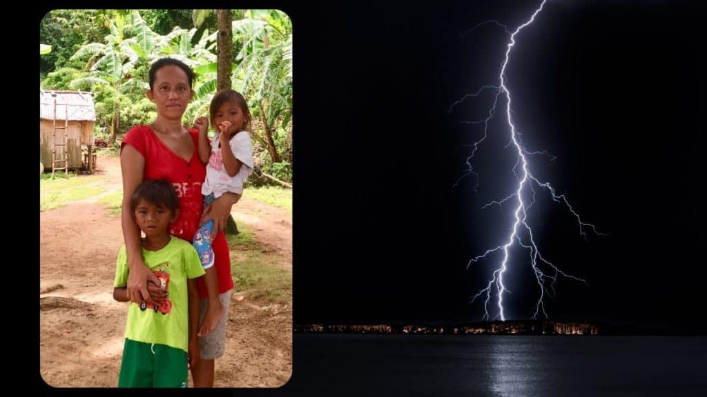 A woman whose husband was killed by lightning as they fished holds her children in sitio Nasuug, Baybay, in Malay, Aklan, Philippines.