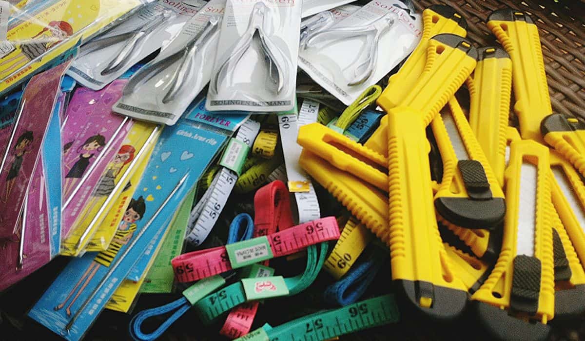 Ati weaving supplies, like box cutters and measuring tapes.