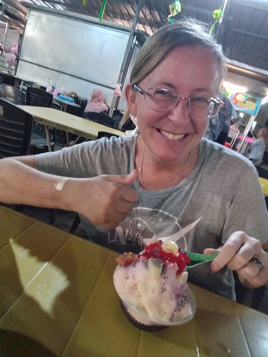 Ellen gives thumb up while eating ice cacang in Penang, Malaysia.