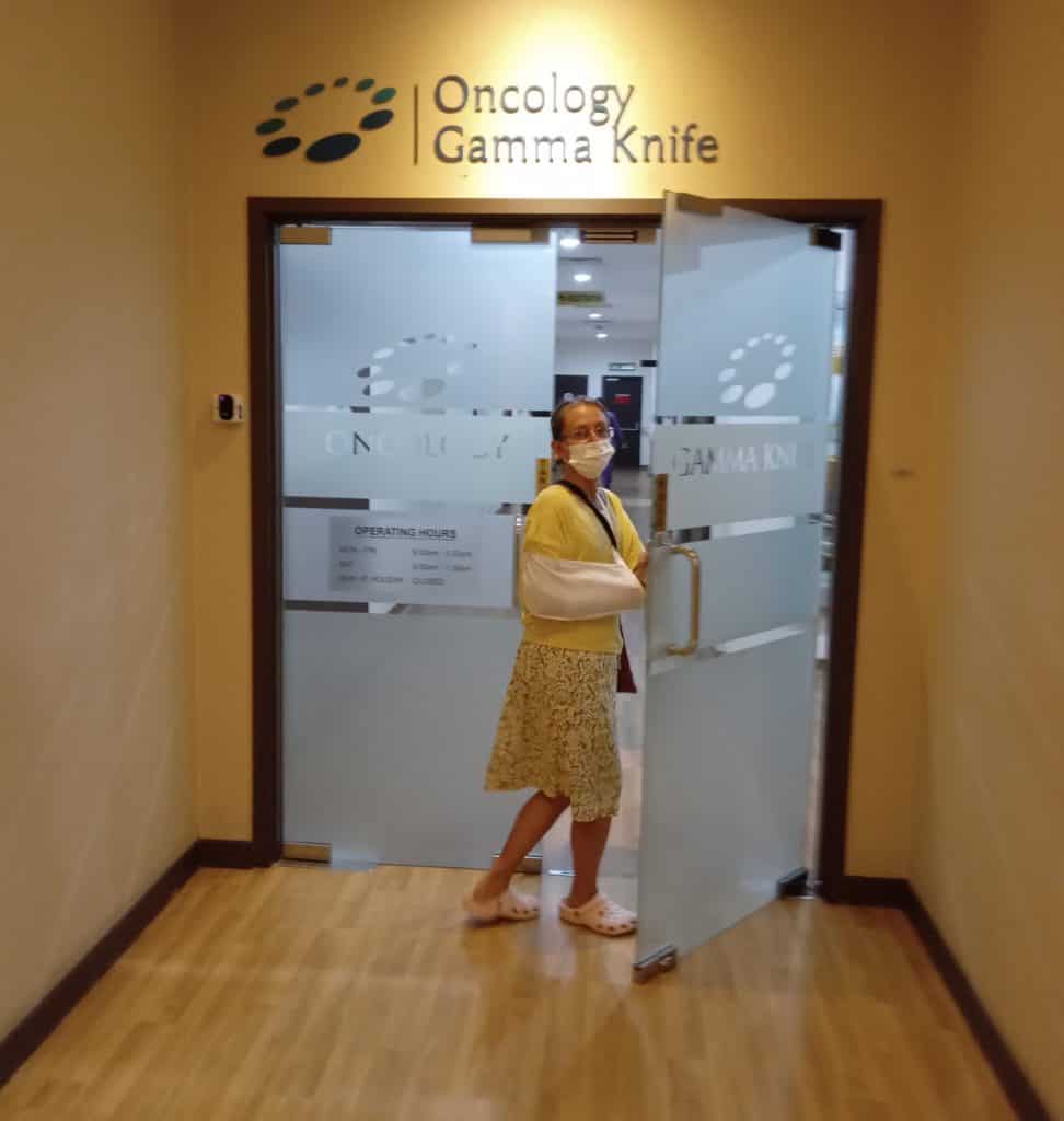 Ellen enters oncology department for check up during world travel without medical insurance.