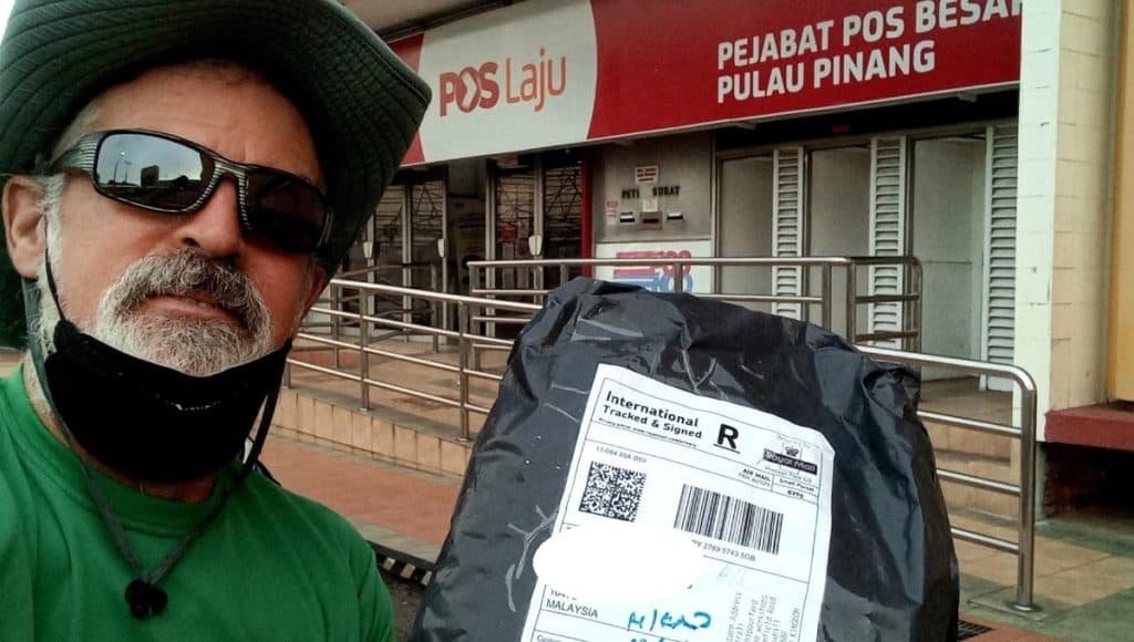 theo holds an e-commerce package sent to malaysia