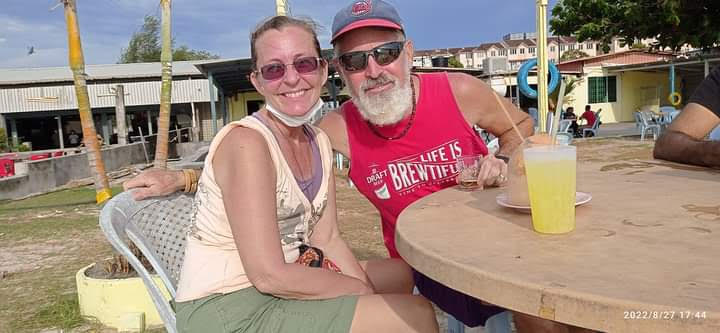 Ellen and Theo at a beach bar in Butterworth, Malaysia, a stop on their slow travel in retirement world tour.