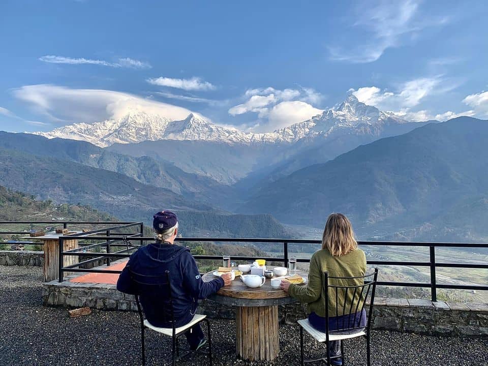 theo and ellen look at the himalayas from a small village in nepal