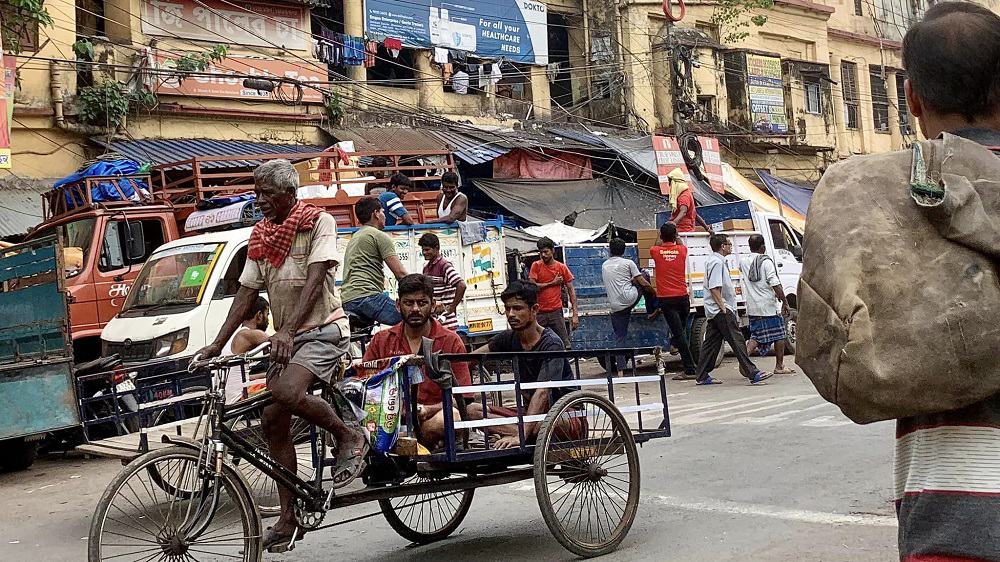 men in a cart in kolkata, india