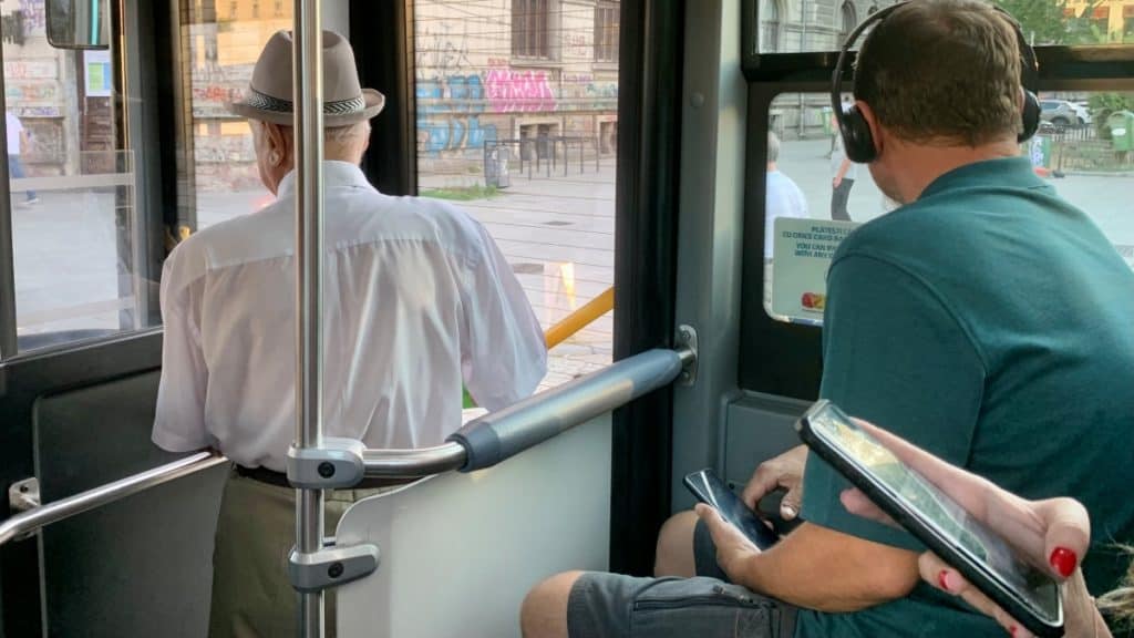 old man and young man on a public bus in bucharest, romania